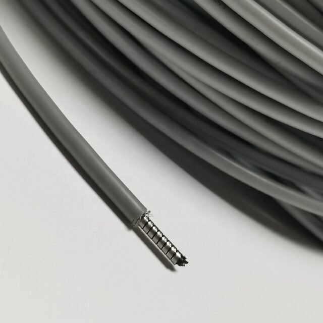 Grey PVC armoured POF cable stripped back to show corrugated metal armour around dual 1.0mm cores