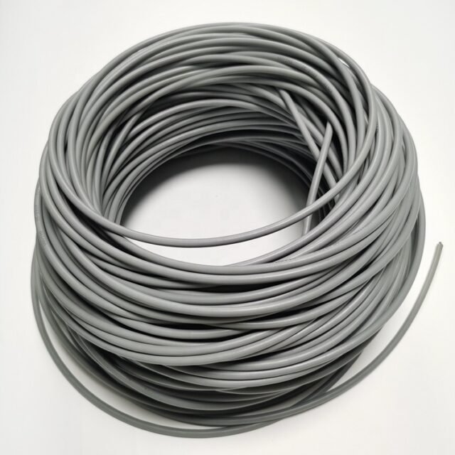 Coil of grey armoured POF cable on white background