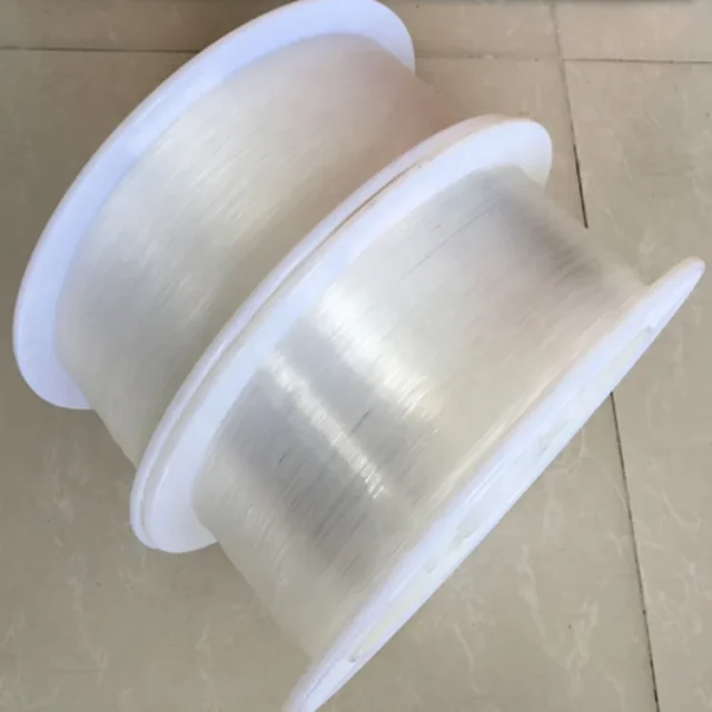 Two white plastic reels wound with clear TB-500 0.5mm PMMA bare fiber
