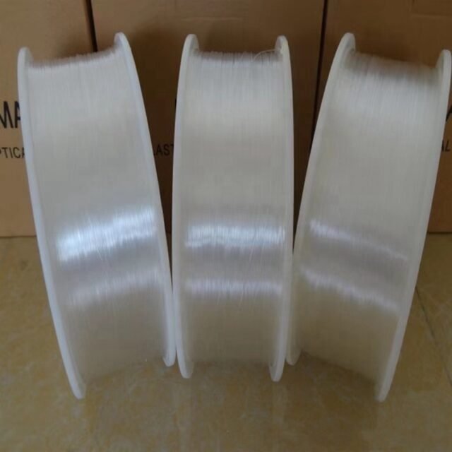Three reels of clear 0.5mm PMMA bare fiber standing upright