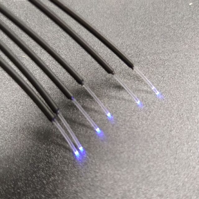 Black PE-jacketed 0.75mm POF cables stripped to clear fiber with blue light at ends