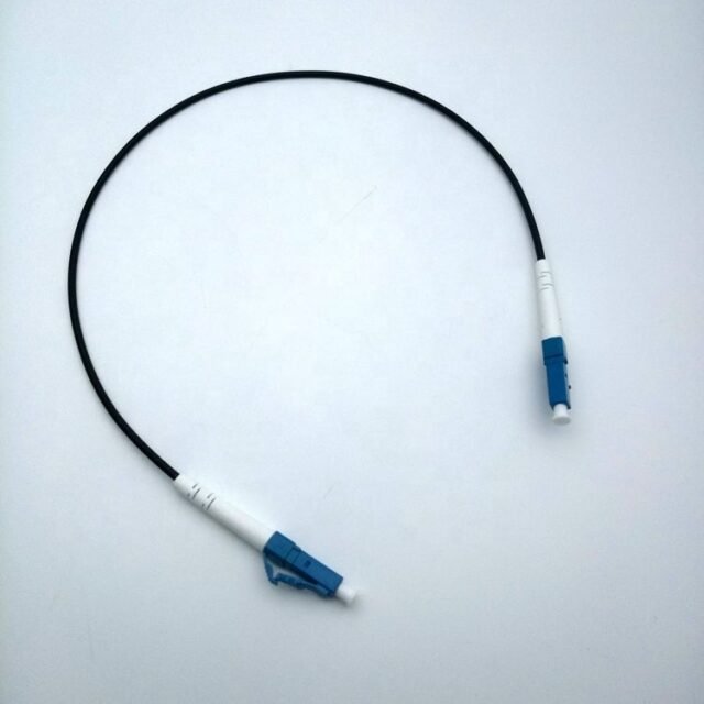 Black LC-LC fiber optic patch cord with blue LC/UPC connectors on white background