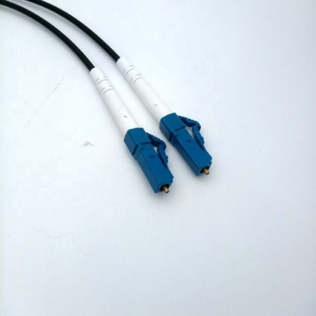 Detail of blue LC/UPC connector on black cable