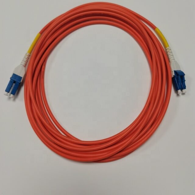 Orange QG-G50-2C duplex industrial jumper with blue-boot LC-style connectors, coiled