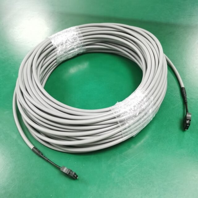 Coiled gray MR-J3BUS03M-B round servo fiber cable with two black F07 connectors