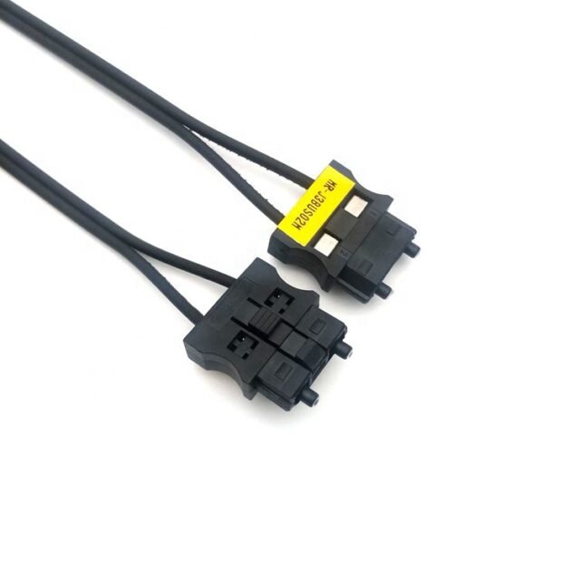 Two black MR-J3BUS F07-AMP duplex connectors with yellow labels on black PE cord