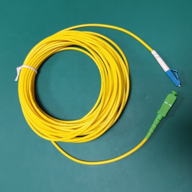 Detail of yellow LC-SC single-mode fiber jumper