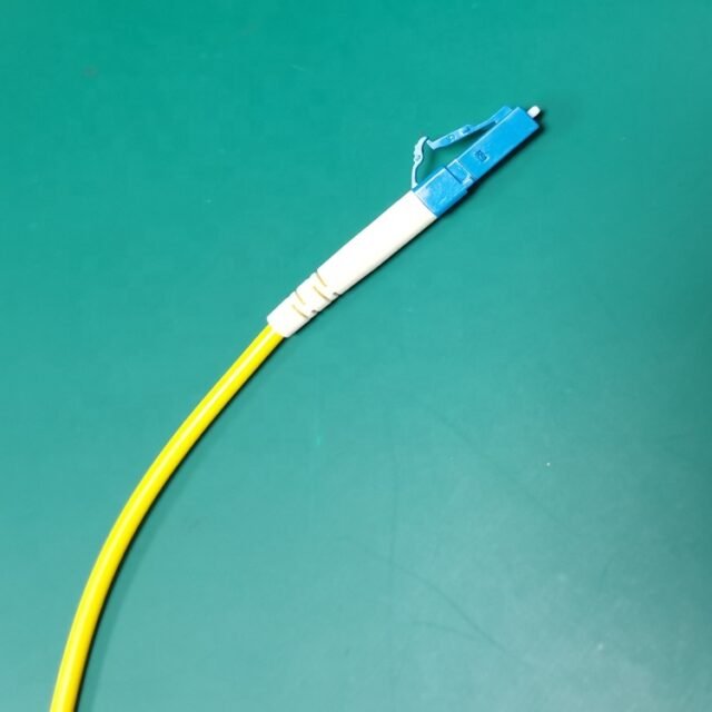Detail of yellow LC-SC single-mode fiber jumper