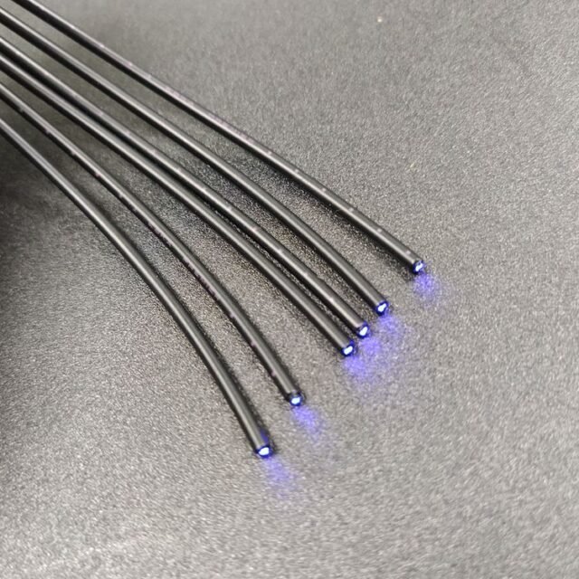 Mitsubishi Eska GH-grade black POF simplex cables with blue light exiting the 1.0mm fiber ends