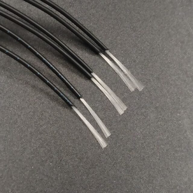 Mitsubishi ESKA SH1048/SH1064 black bundle cables stripped back to show the clear 0.265mm PMMA fiber bundle ends