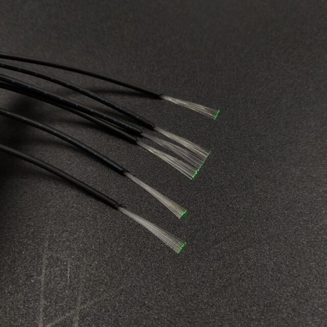 Bundle POF cables with green light exiting the clear fiber bundle ends