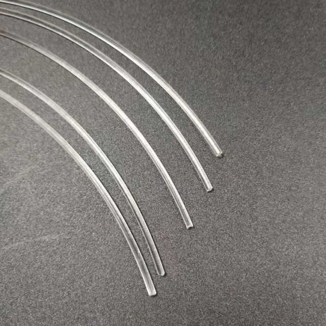 Clear Mitsubishi Eska SK-60 PMMA end-glow fibers on dark background