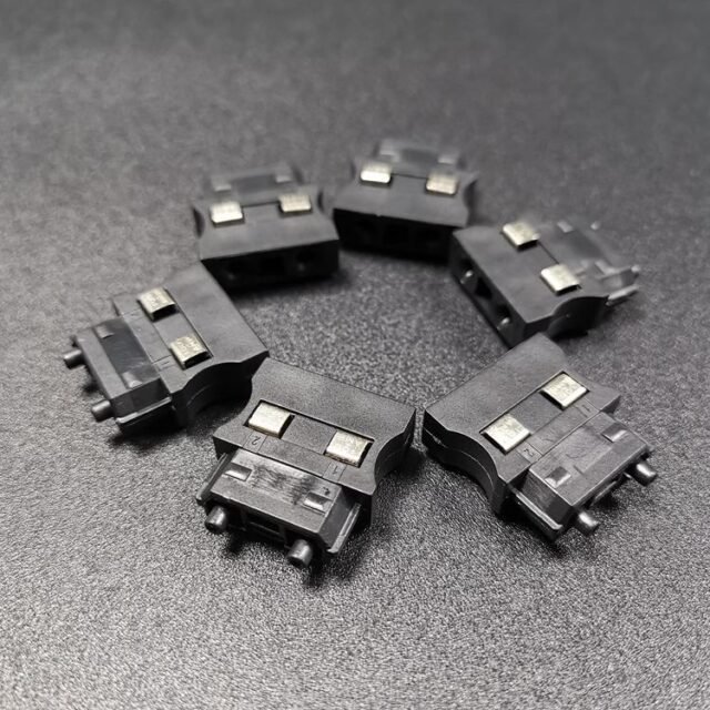Row of black AMP 1123445-1 duplex POF connectors on dark bench
