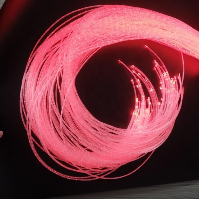 Coiled pink end-glow sparkle PMMA fiber bundle glowing on black