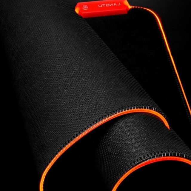 Orange RGB mouse pad close-up showing the woven edge and glow controller