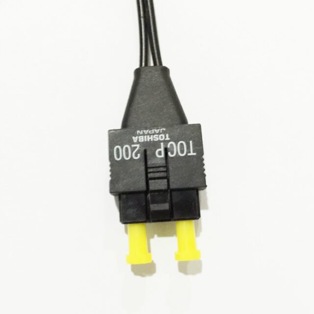 Close-up of black TOCP 200 TOSHIBA JAPAN duplex connector with yellow ferrule caps and black duplex lead