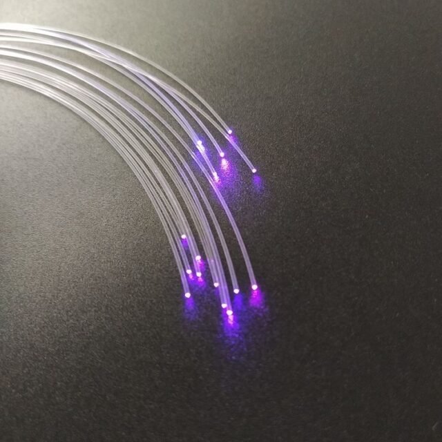 Bundle of clear 1.0mm PMMA end-glow fibers glowing purple at the ends