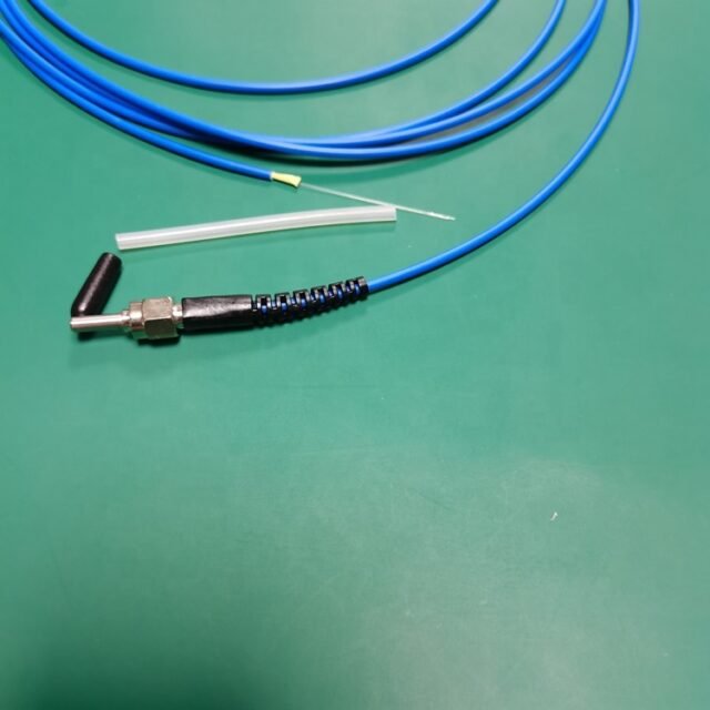 Blue SMA905 POF pigtail with metal connector and bare fiber tail on green work mat