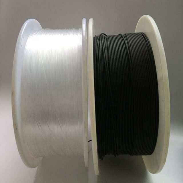Clear bare-fibre reel next to a black-jacketed POF reel