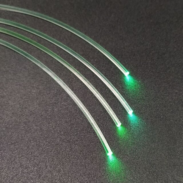 Clear PMMA fibres glowing green at the ends